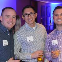 Three alumni pose with their drinks at the Chicago Alumni Reception